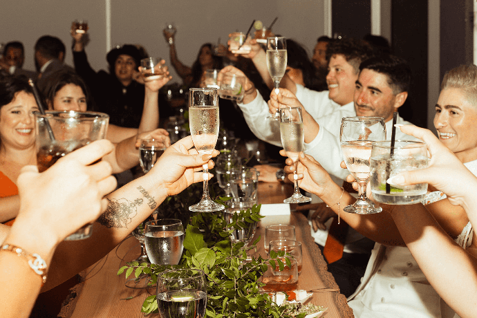 Wedding guests toasting and cheering at FruitCraft celebration