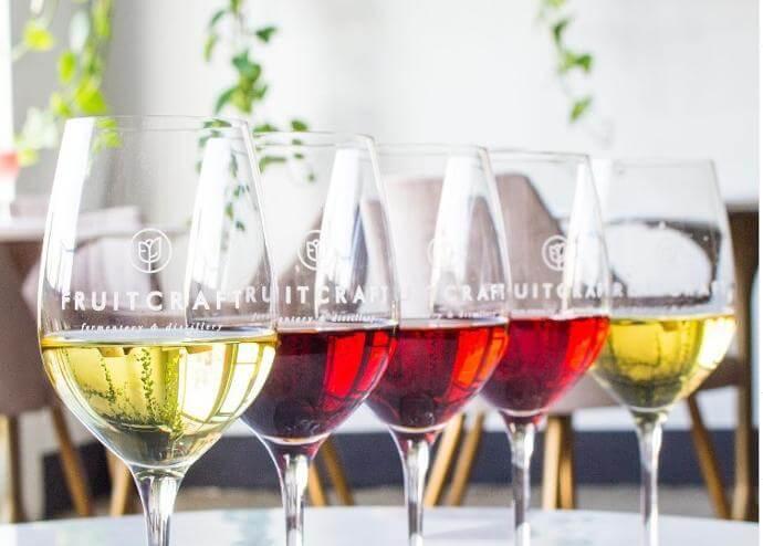 Wine glasses and bottles lined up for FruitCraft tasting or event